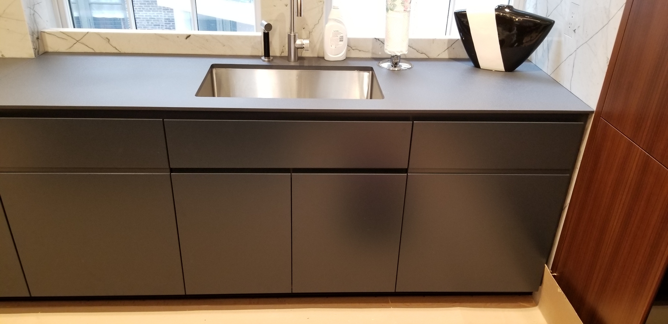Custom floor to ceiling cabinetry with bespoke shadow reveals, integrated brass pulls